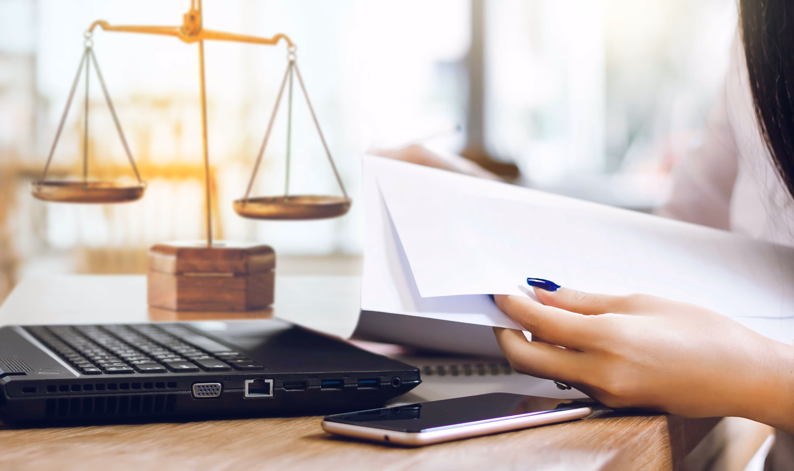 Scales of justice on a desk with case documents under review